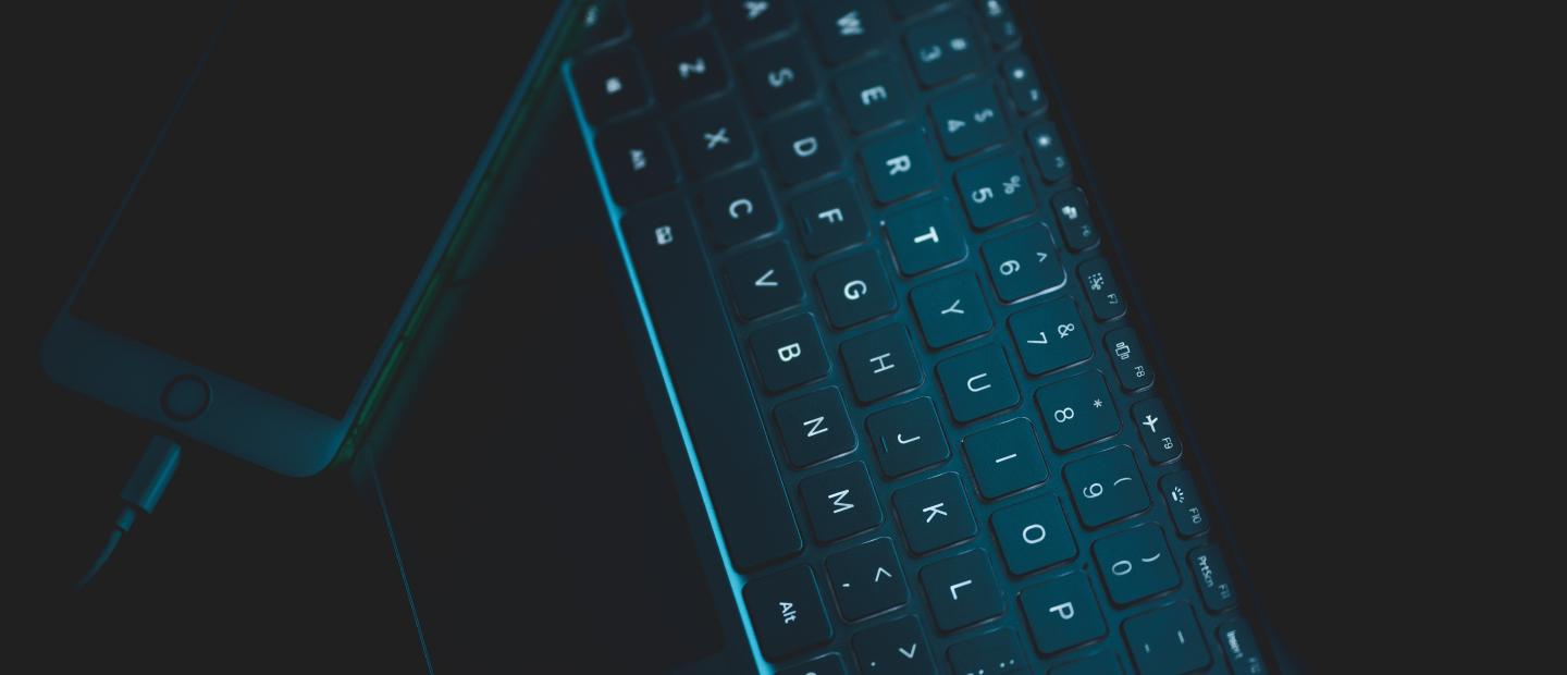 Desktop mit Tastatur und Handy dunkel